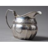 An Irish Victorian silver cream jug with engraved decoration, 4.8oz troy approx