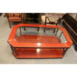 A contemporary figured ash and lacquered octagonal coffee table with inset glass plate and