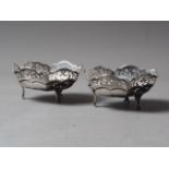 A pair of silver bonbon dishes with pierced decoration, on three scrolled supports, 4.3oz troy