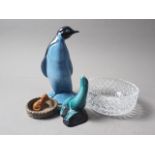 A Poole Pottery penguin, 8 1/4" high, a Poole Pottery seal, 4 1/2" high, a Wade dog in a basket