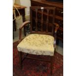 A George III mahogany triple splat back elbow chair with stuffed over seat, on square taper