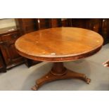 A late 19th century mahogany circular dining table, on trefoil base with paw feet, 47 1/2" dia