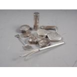 A silver swizzle stick, five white metal and silver pill boxes, various, a silver clip and other