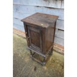 An oak pot cupboard of 17th century design with through pegged frame, on turned and stretchered