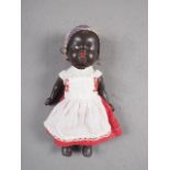 A post-war African doll, in costume, 10" high