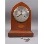 An Edwardian arch topped walnut cased mantel clock with silvered dial and Arabic numerals, 12 1/2"