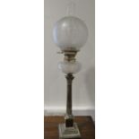 A silver plated Corinthian column oil table lamp with cut glass reservoir and etched shade, 29" high