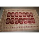 A Bokhara rug of traditional design with fourteen guls on a grey ground, 51" x 73" approx (edges