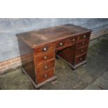 A mahogany double pedestal desk, fitted nine drawers with ring handles, on ogee bracket feet, 48"