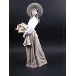 A Nao figure of a woman carrying wheat, 15 1/2" high, and a studio pottery vase, 23" high