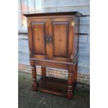 A Titchmarsh & Goodwin oak mahogany banded and inlaid cupboard enclosed two doors, on stand,