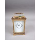 A brass cased carriage clock with white enamel dial and Roman numerals, with key supplied, by