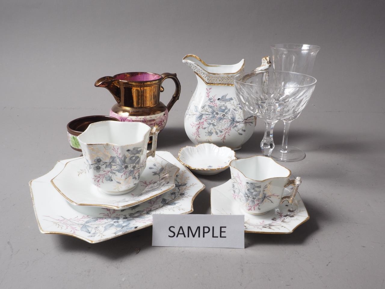 A Continental Art Deco style part combination service with floral decoration, glass flutes and