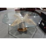 An octagonal glass top coffee table, on carved pine base, formed as acanthus leaves with gilt edges,