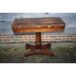 An early 19th century rosewood fold-over top card table, on pedestal and quatreform base, 36" wide