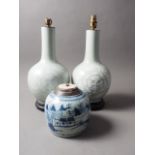 A pair of Chinese celadon glazed vases with dragon, flower and cloud decoration, on hardwood