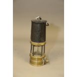 A miners early 20th century Richard Johnson, Clapham & Morris brass and base metal safety lamp, 9"