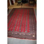 A Bokhara rug with octagonal and hooked guls on a red ground, 108" x 74" approx (worn)