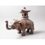 A bronzed metal model of an elephant with howdah, 12" high