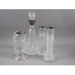 A silver collared and cut glass decanter, 12 1/2" high, a pair of white metal mounted vases and