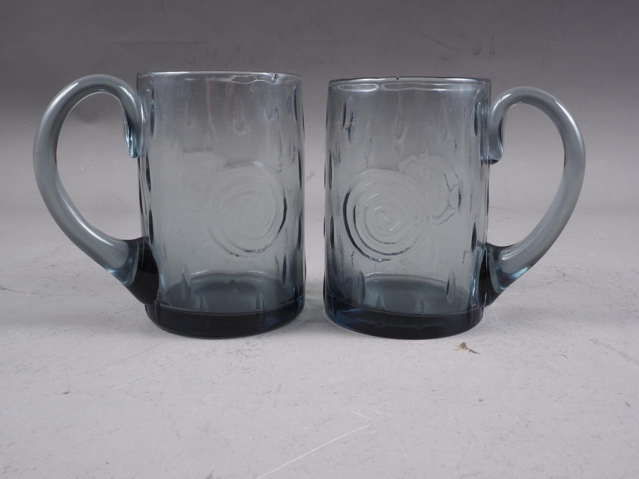 A pair of Whitefriars smoked glass mugs, 4 1/2" high (one with crack)