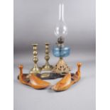 A pair of 19th century brass candlesticks, a pair of wooden shoe lasts, a leather and brass chest