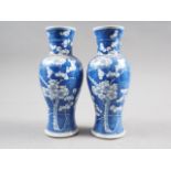 A pair of 19th century Chinese blue and white baluster vases with prunus decoration, four-