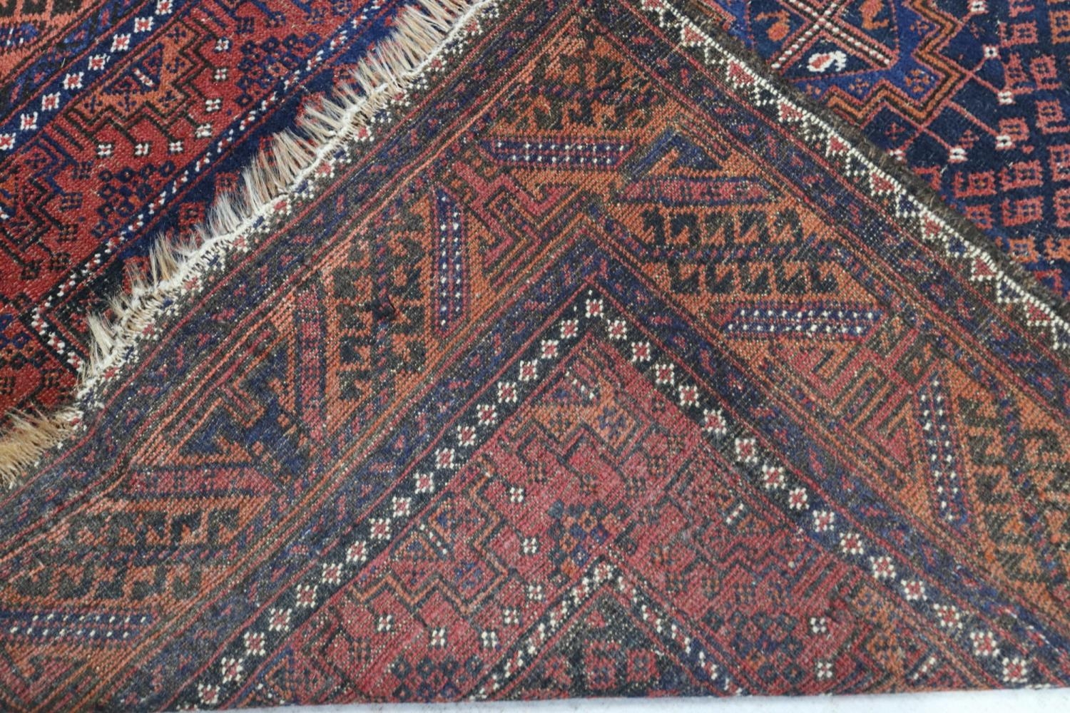 A Bokhara type rug with four stepped medallions on a blue ground with geometric borders in shades of - Image 3 of 3