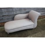 A modern scroll end chaise-longue, upholstered in a light grey fabric, 32 1/2"H x 27 3/4"W x 65" L
