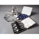 A quantity of silver plated cutlery, Mappin & Webb soup spoons, a teapot, a bell, two cased sets