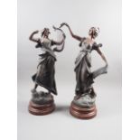 A pair of bronzed figures, "La Glorie" and "La Musique", on Bakelite bases, 21" high, and a pair