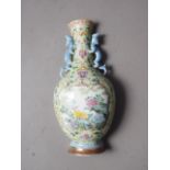 A Chinese famille rose wall pocket, formed as a vase with floral panel and vase decoration, relief