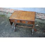 A burr walnut and banded drop leaf coffee table, fitted two drawers, on turned and splay supports,