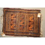 A tribal woven mat with bird design, in shades of natural and orange on a brown ground, 25 1/2" x 16
