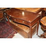 A mahogany serpentine front side table, fitted three drawers, on square taper supports and spade