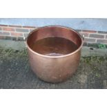 A copper cauldron with wrought iron handle, 24" dia x 16 1/2" high