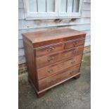 A 19th century oak and mahogany chest of two short and three long graduated drawers, on bracket