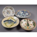 A tin-glazed bowl with fish decoration, 12" dia, two other bowls and a faience-shaped edge plate, 9"