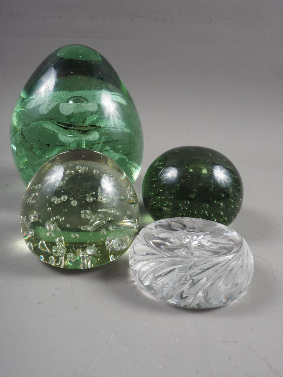 A 19th century glass door stop, two bubble glass paperweights and a cut glass paperweight