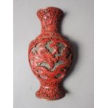 A Chinese cinnabar lacquered wall pocket, formed as a vase with dragon and flower decoration, 9"
