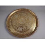 A Middle Eastern? circular brass tray with engraved and embossed decoration, 22 3/4" dia