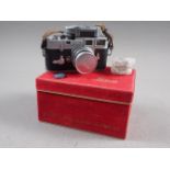 A Leica M3 camera number 837 828  with Summicron f=5cm 1.2 lens, light meter and two filters, in box
