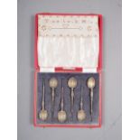 A set of six silver gilt commemorative coffee spoons with engraved decoration, in case