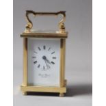 A David Peterson brass cased carriage clock with Swiss movement, white enamel dial and Roman