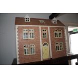 A late 20th century brick effect finish dolls house of three stories with furnishings and effects,