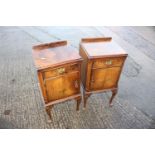 A pair of walnut bedside cupboards, fitted one drawer over one door over, on cabriole supports, 15
