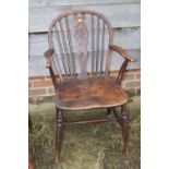 A 19th century Windsor wheelback elbow chair with elm panel seat and a pair of companion side chairs