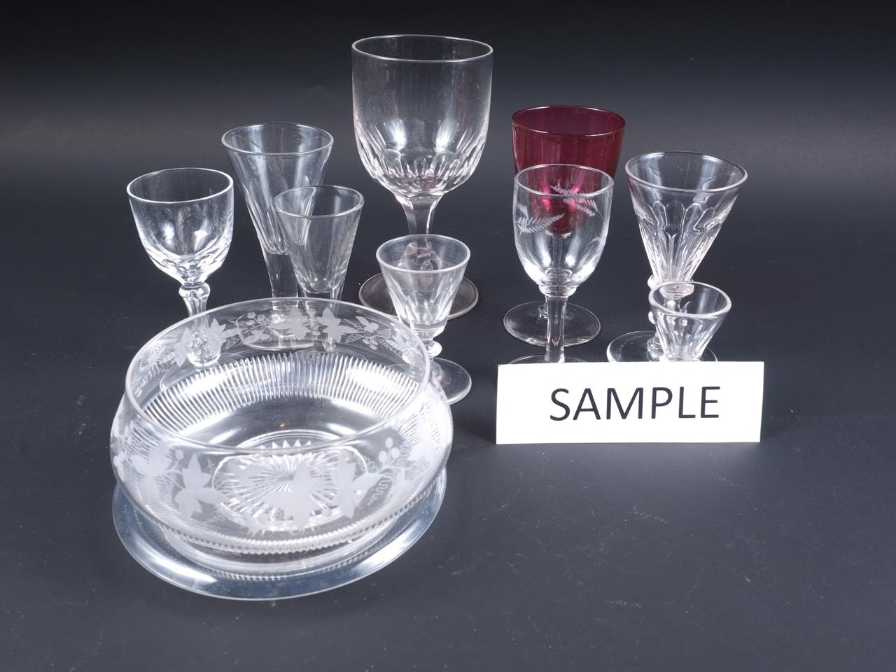 A selection of 19th century and later drinking glasses and three engraved glass bowls