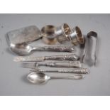 Three silver napkin rings, a silver cigarette case, 5oz troy approx, and silver feruled cutlery,