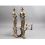 A pair of brass andirons, formed as a Classical female figure, 17 1/2" high, and a cast iron door